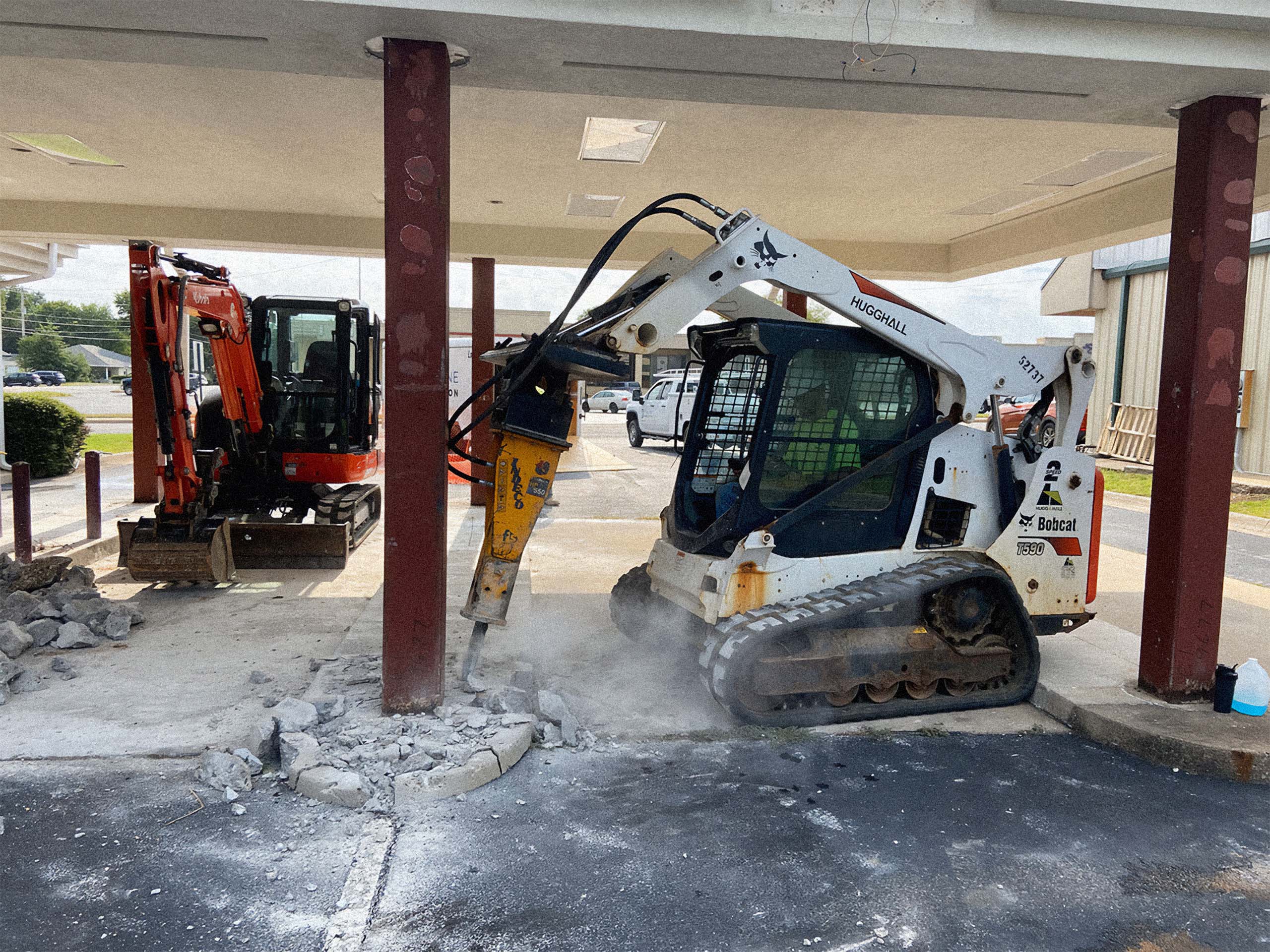 Bobcat demoing into concrete slab