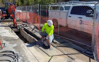 Man cutting a trench in concrete